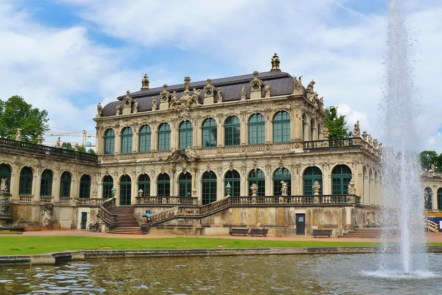 Zwinger Palace in Dresden, Germany: a stunning Baroque palace with a reflecting pool and fountain.