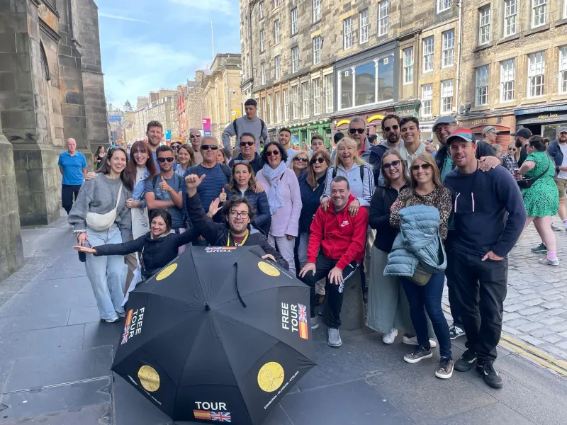 Happy tourists on a free walking tour in Edinburgh, Scotland.