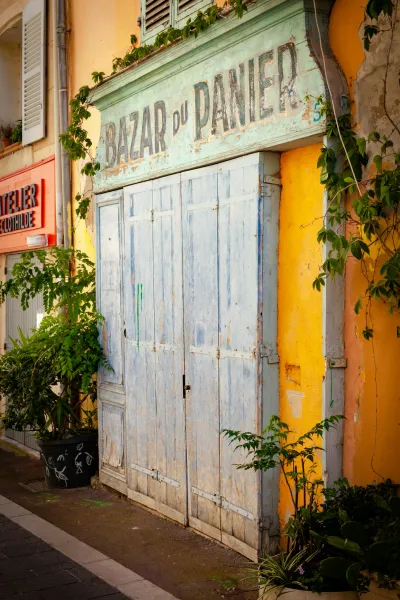 A weathered shopfront in France, with a faded sign reading "BAZAR du PANIER."