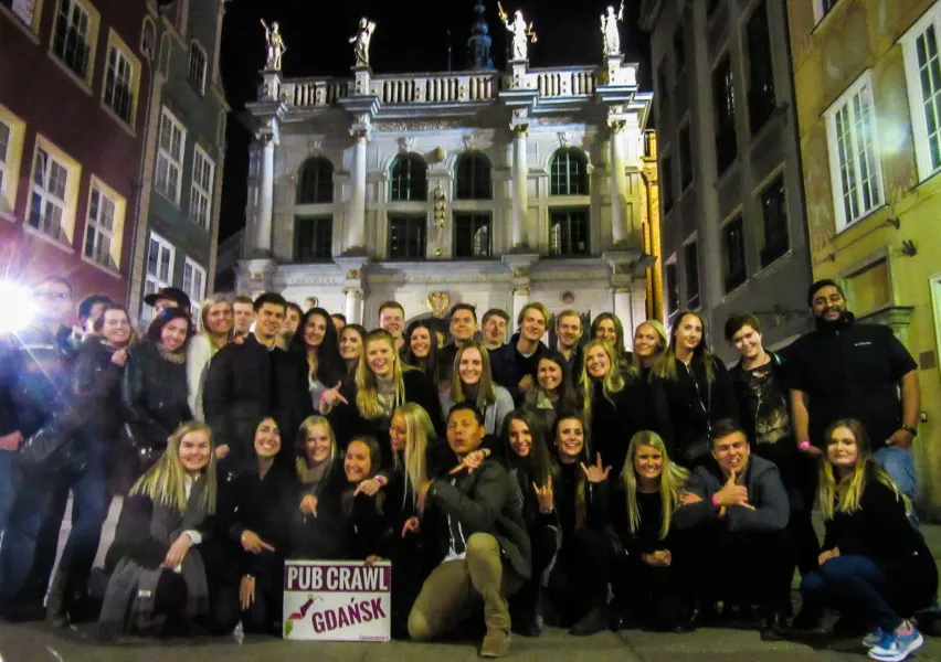 Happy tourists on a Gdańsk pub crawl.