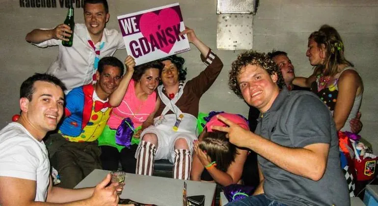 Happy tourists in Gdańsk, Poland, enjoying a night out.
