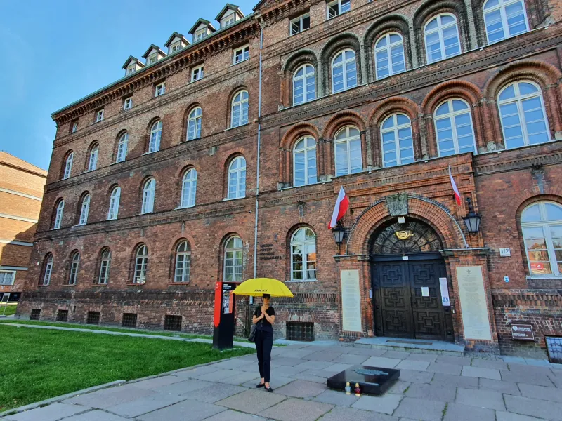 Tourist exploring a historical brick building in Gdansk, Poland.