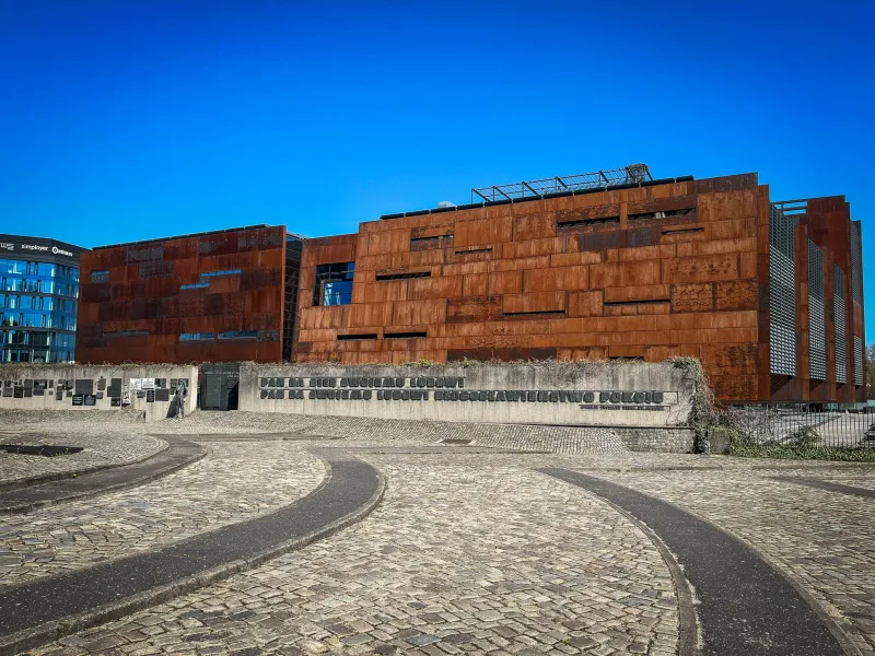 The European Solidarity Centre in Gdansk, Poland, a modern museum with a rust-colored facade.