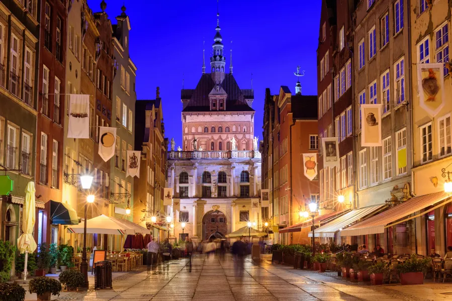 Night view of Gdansk's Golden Gate and Długi Targ street.