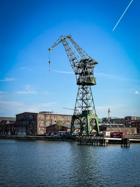 A large green harbor crane in Gdansk, Poland.