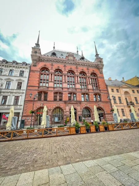 A beautiful brick building in a German city square.