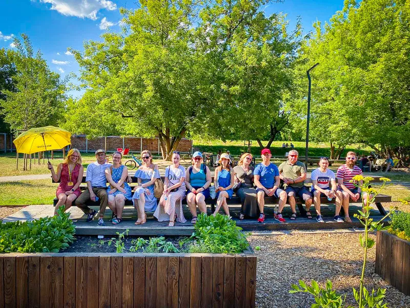 Happy tour group enjoying a sunny day in a German park.