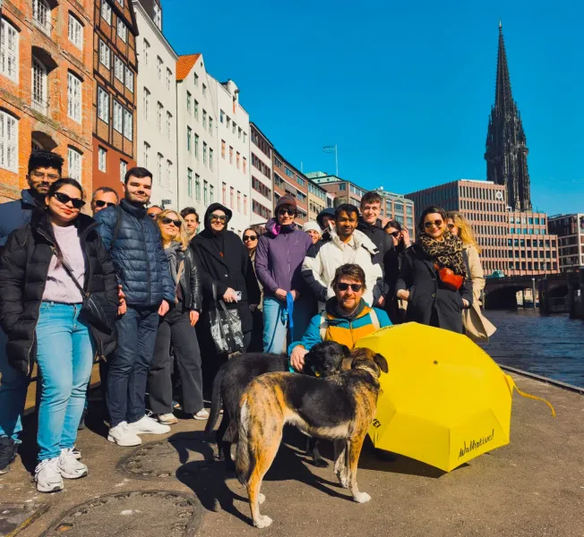 Happy tour group in Hamburg, Germany, enjoying a city tour along the canal.