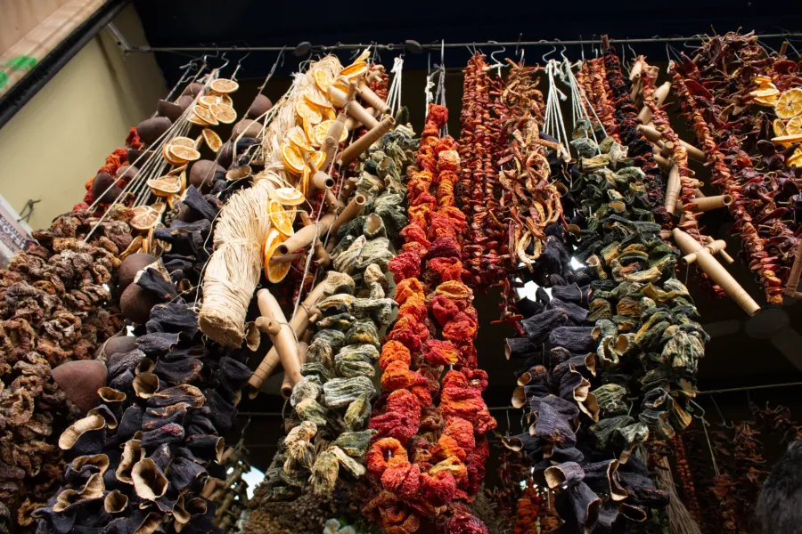 Colorful strings of dried fruits and vegetables hang in an Istanbul market.