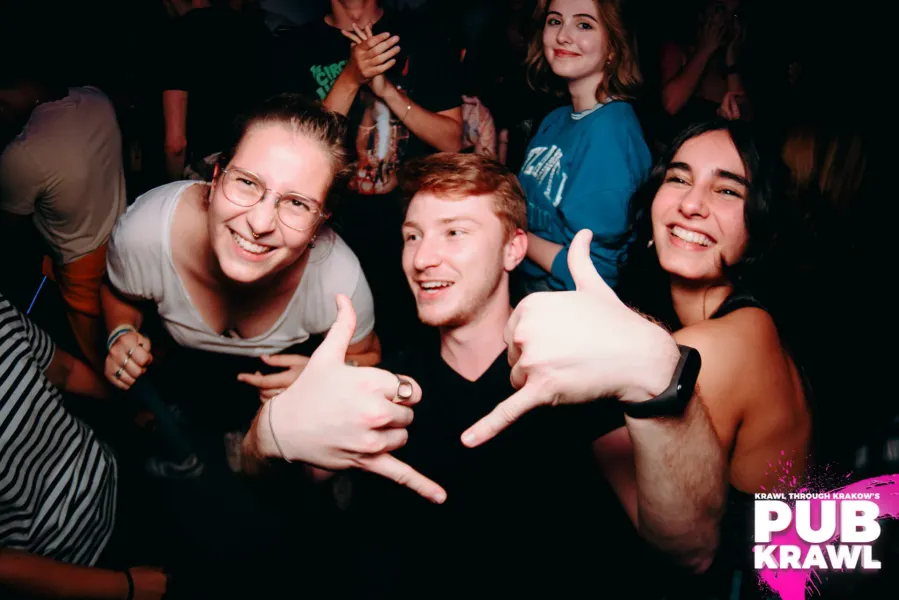Happy pub crawlers in Krakow, Poland, enjoying the nightlife.