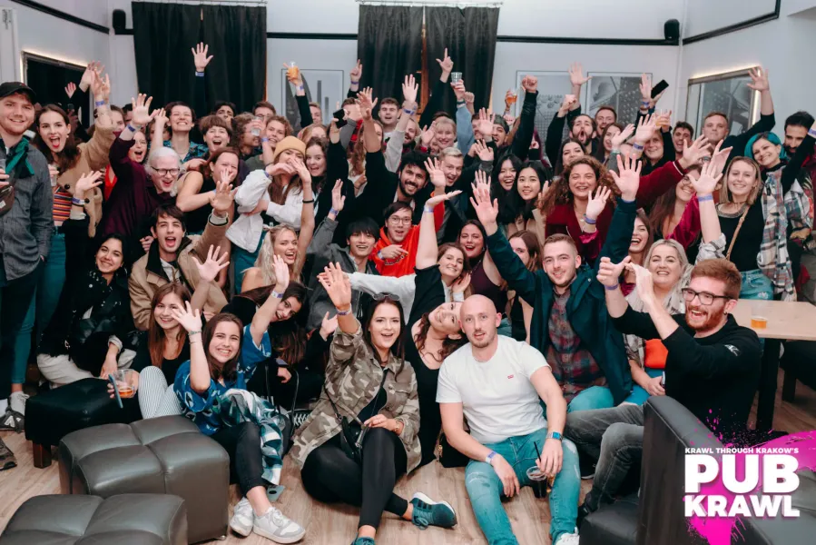 Happy tourists enjoying a pub crawl in Krakow, Poland.