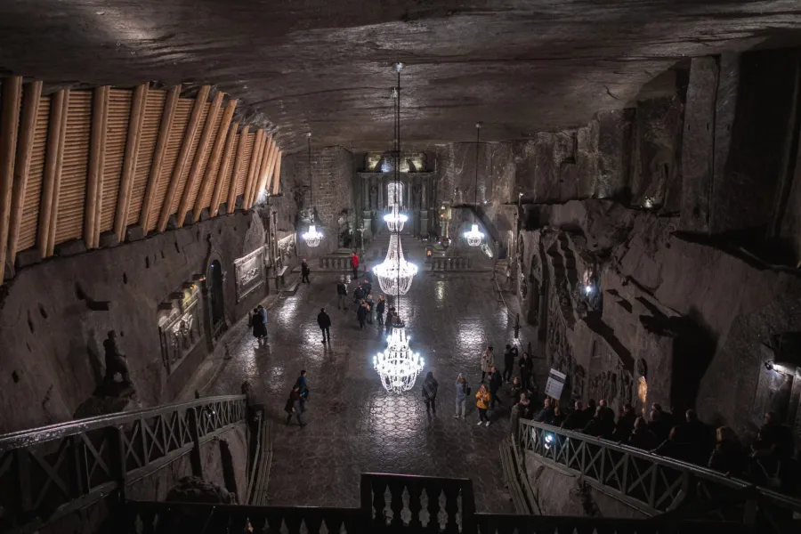 Awe-inspiring view of the Wieliczka Salt Mine's underground chapel, filled with tourists.