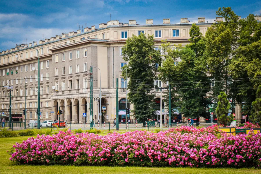 A guided walking tour of Communist Krakow's Nowa Huta district, featuring beautiful architecture and vibrant flowerbeds.