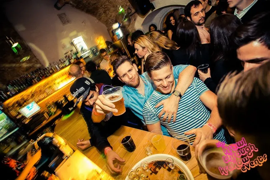 Friends enjoying a Krakow pub crawl.