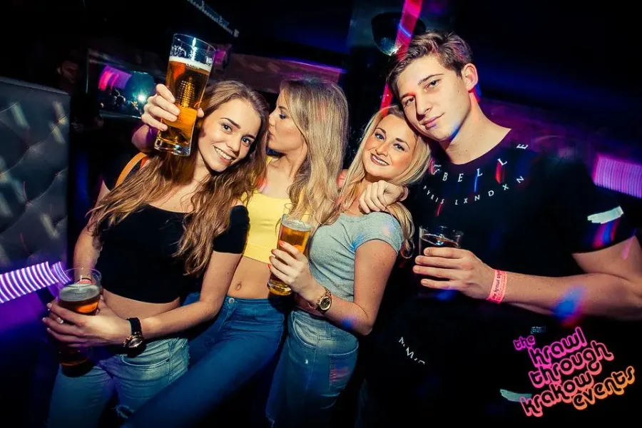 Group of friends enjoying a pub crawl in Krakow.