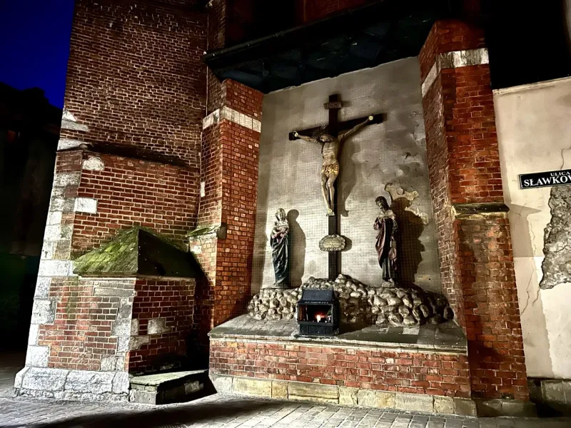 Nighttime view of a religious shrine in Krakow, Poland.