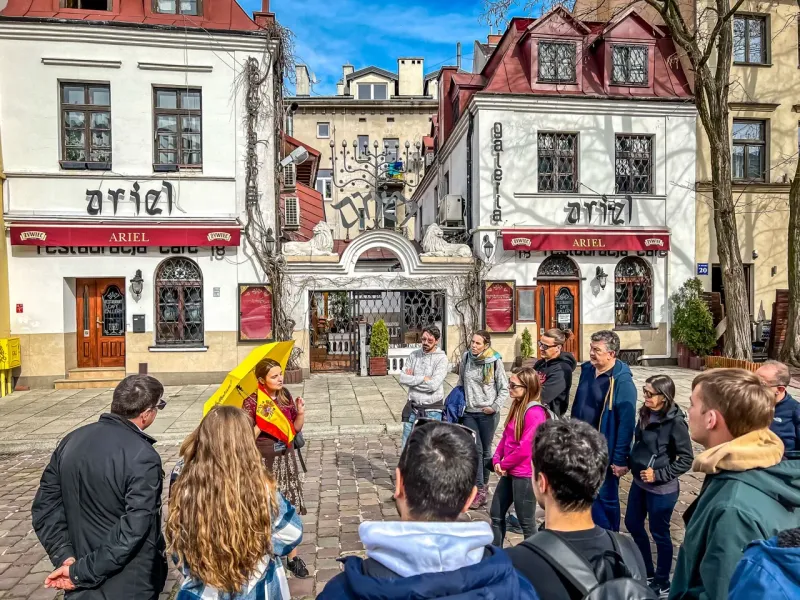 Guided tour group in Krakow's Kazimierz district, outside the Ariel Restaurant.