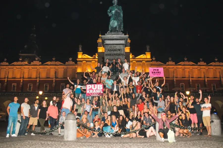 Large group enjoying a Krakow Pub Crawl at night.
