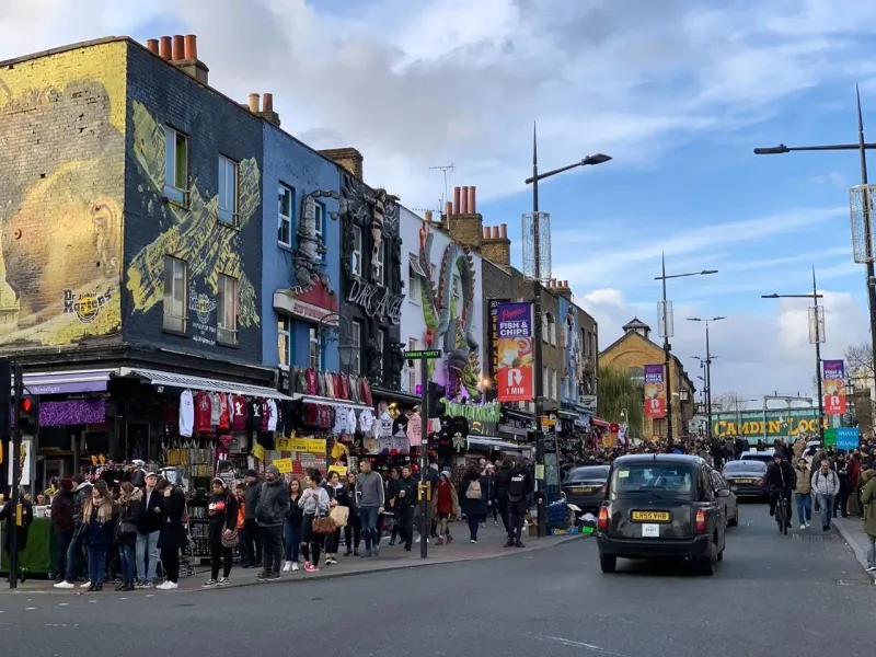 Bustling Camden Market in London, England, showcasing vibrant street art and diverse shops.