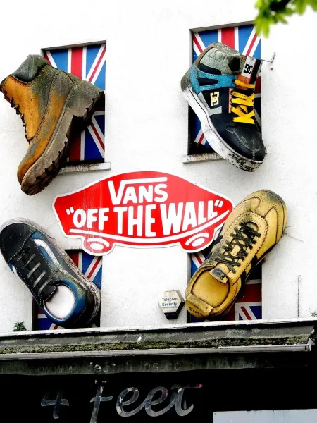 Giant shoes adorn a building in London, creating a fun and unique street scene.