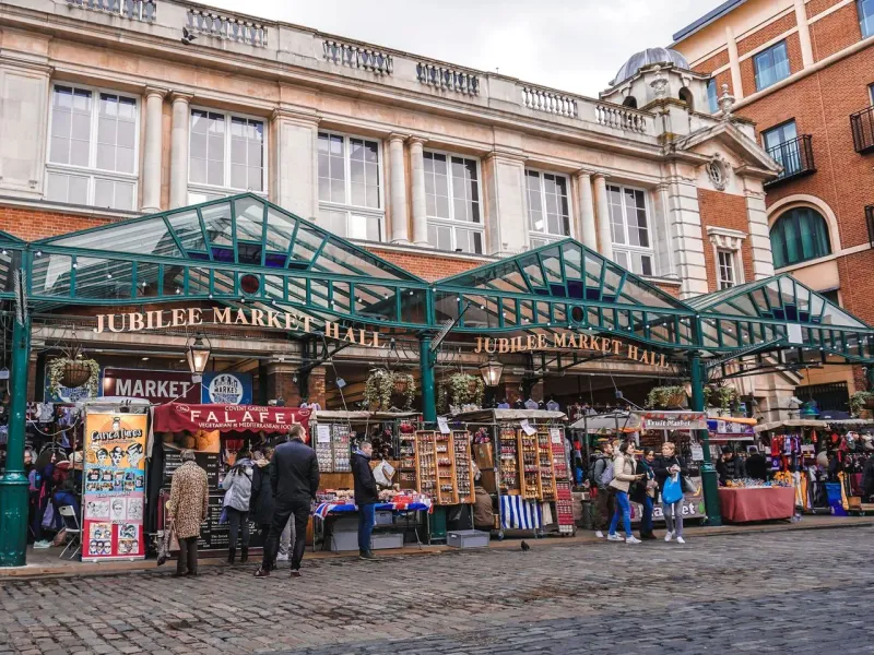 Jubilee Market Hall in London, England, bustling with tourists and vendors.