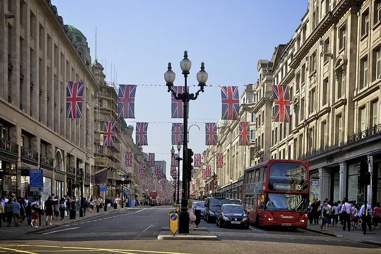Festive Regent Street in London, adorned with Union Jack flags.