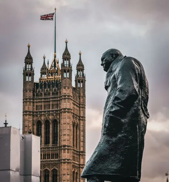 Statue of Winston Churchill with the Palace of Westminster in the background in London.