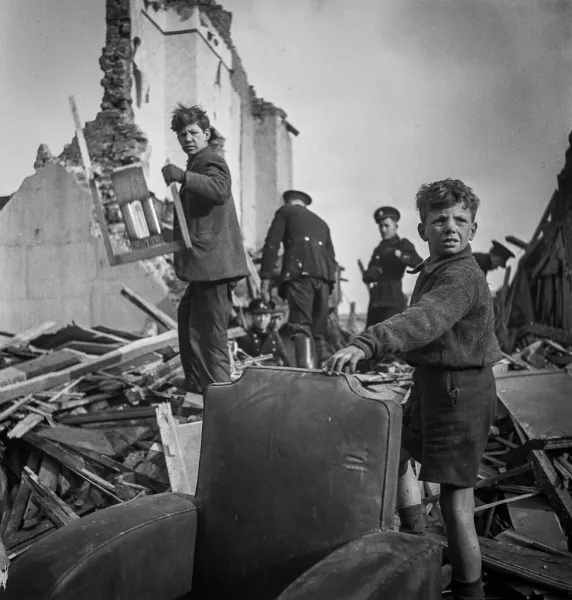 London children amidst WWII rubble.
