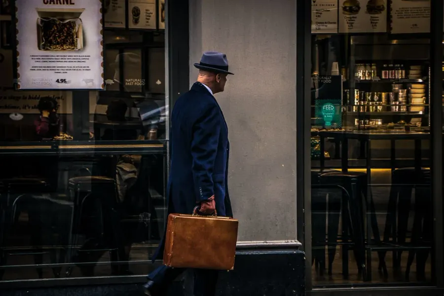 A man walks past a cafe in London.