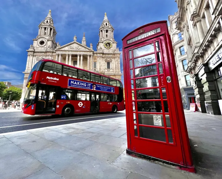 Iconic London scene: red bus, phone booth, and St. Paul's Cathedral.
