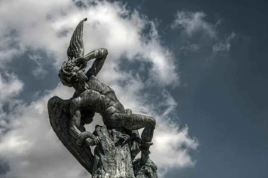Dramatic bronze statue of a fallen angel in Madrid, Spain.