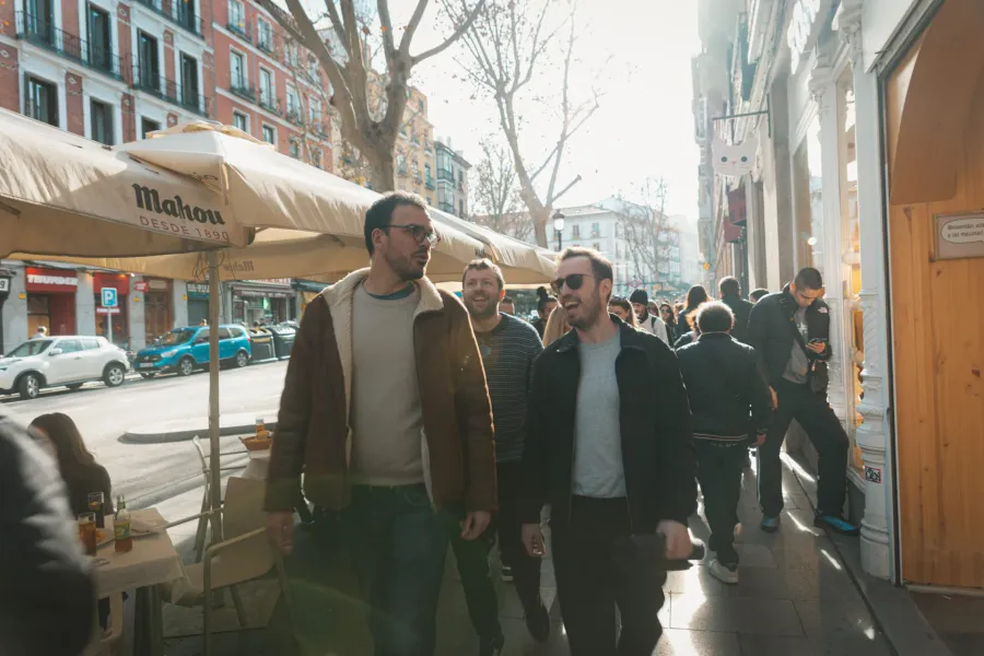Tourists enjoying a walking tour in sunny Madrid.