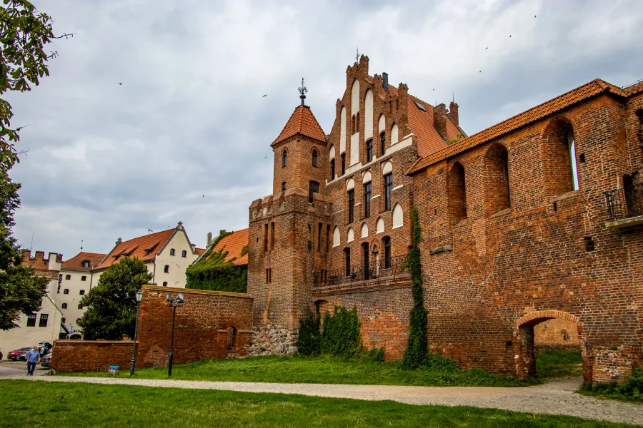 Explore the majestic Malbork Castle in Poland.