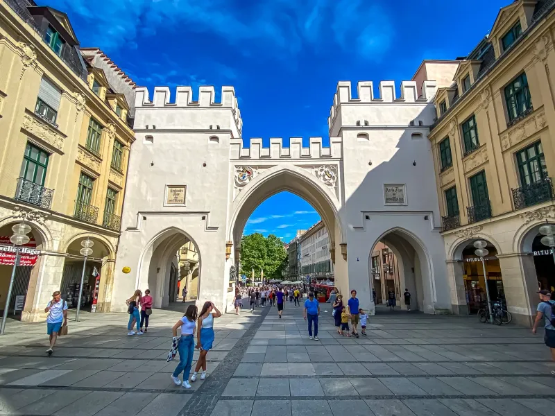 Tourists exploring the historic Karlstor in Munich, Germany.