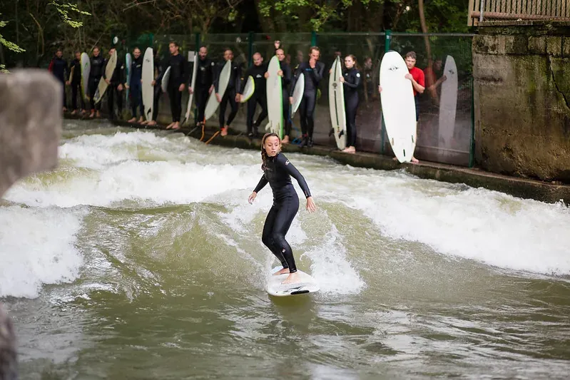 Surfer riding a wave at the Eisbach wave in Munich.