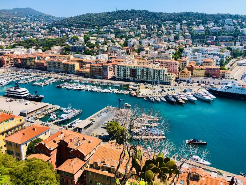 Panoramic view of Nice's harbor, filled with yachts and boats.