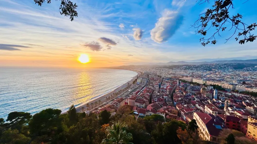 Stunning sunset over Nice, France, showcasing the city's coastline and architecture.