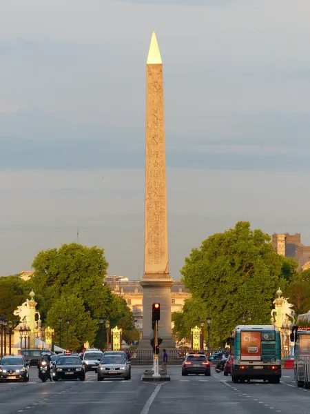 The Luxor Obelisk in Paris, France, stands tall amidst city traffic.