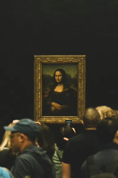 Tourists admiring the Mona Lisa at the Louvre Museum in Paris.