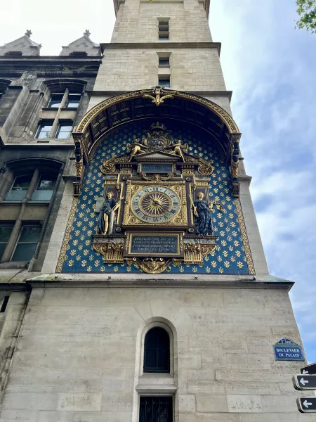 Intricate astronomical clock on a building facade in Paris.