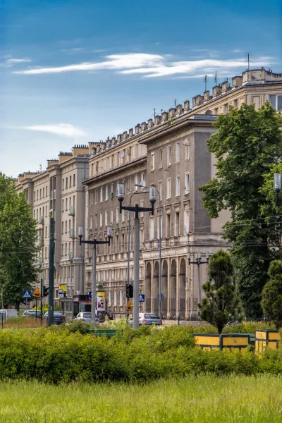 A charming street scene in a Polish city, featuring beautiful architecture and lush greenery.