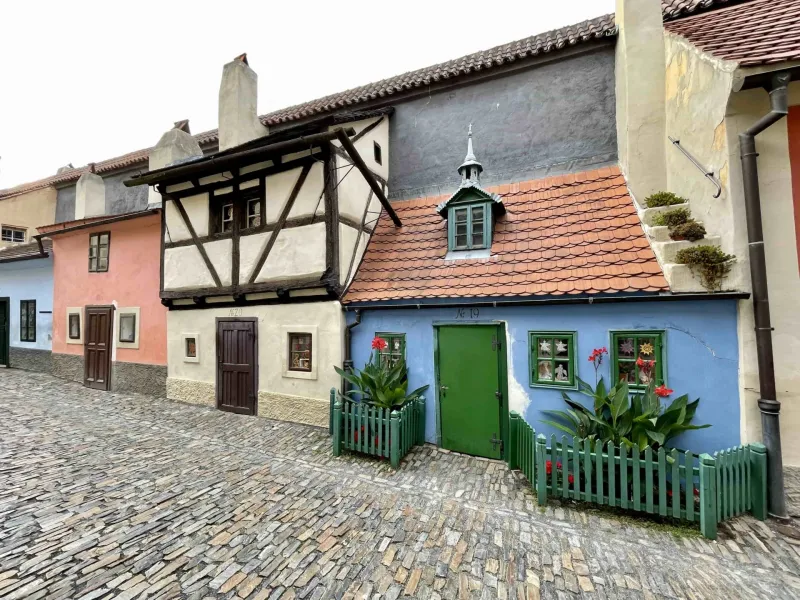 Charming street in Prague Castle with colorful historic houses.