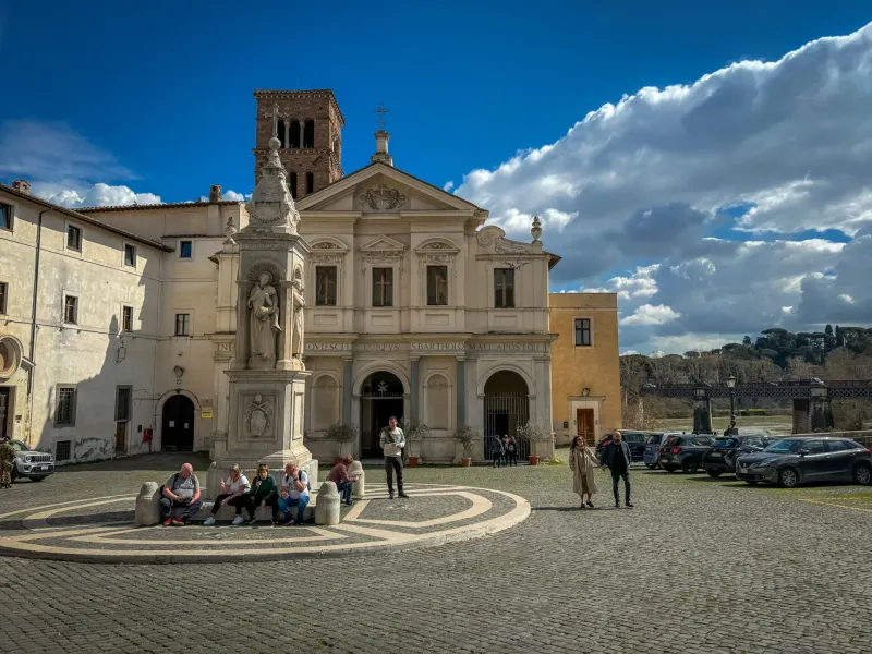Tourists exploring the Basilica di San Bartolomeo all'Isola in Rome.