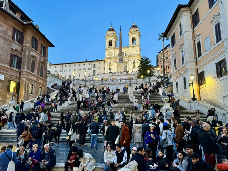 Tourists enjoying the Spanish Steps in Rome at dusk.