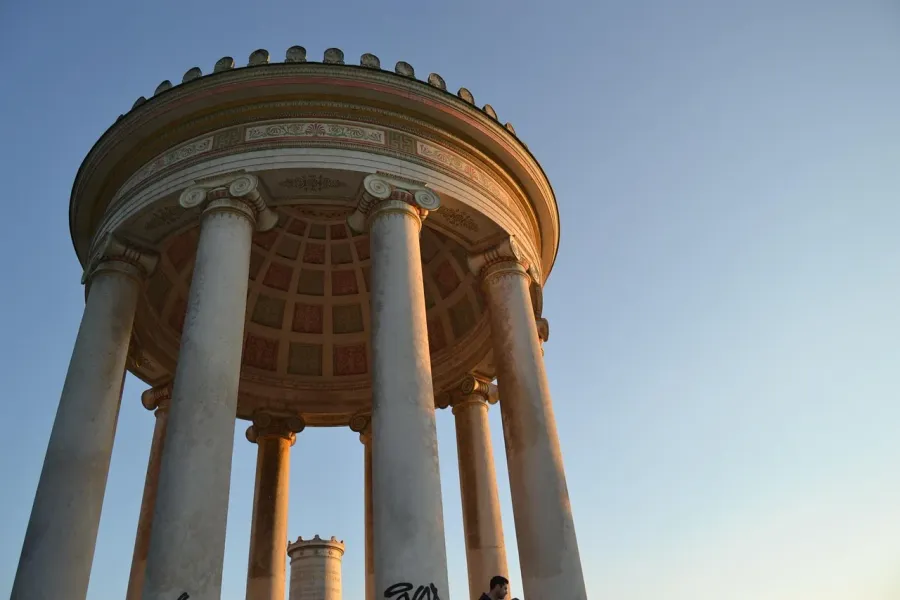 A couple admires the Temple of Diana in Rome at sunset.