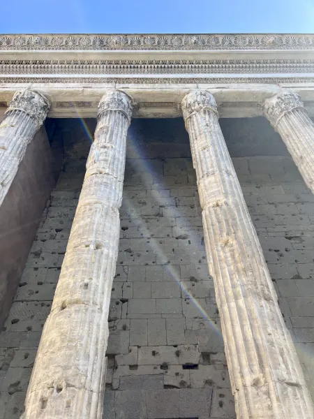 Ancient Roman columns and temple wall in Rome, Italy.