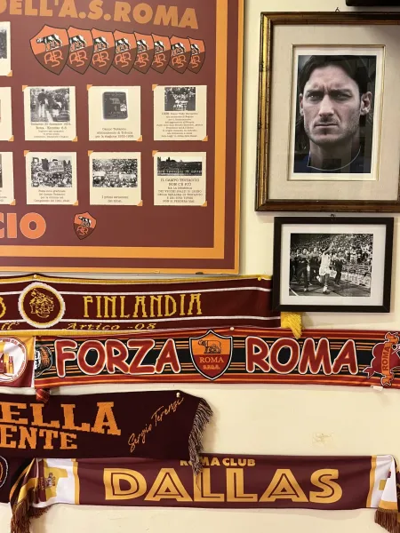 AS Roma memorabilia displayed on a wall in Rome.