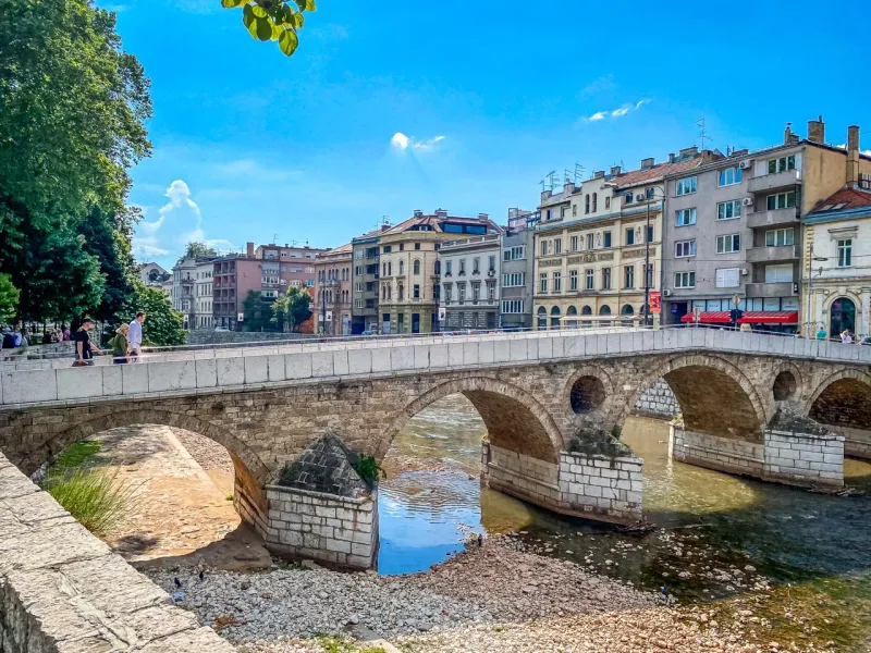 Tourists enjoying a city tour on the historic Latin Bridge in Sarajevo.