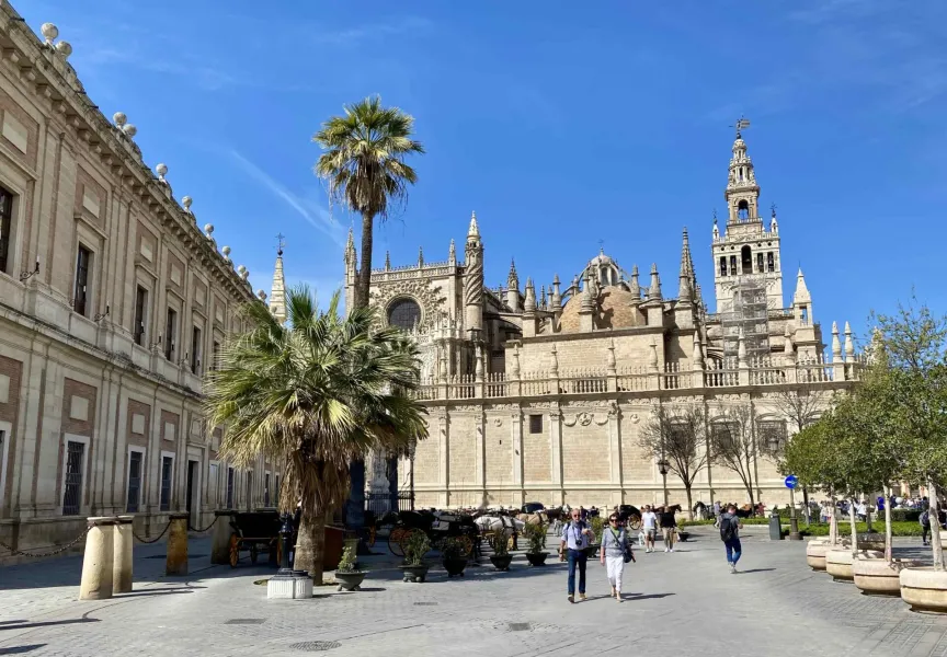 Tourists exploring the magnificent Seville Cathedral in Spain.