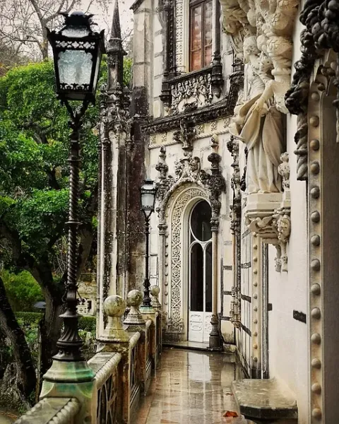 A rain-soaked walkway at Quinta da Regaleira Palace in Sintra, Portugal.
